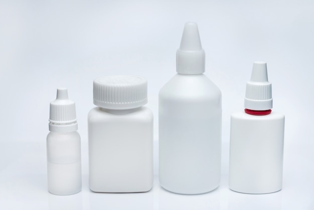 White containers for medicines on a white background