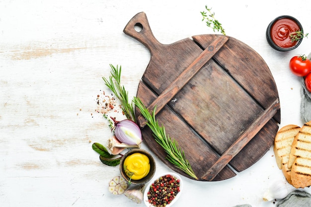 White cooking banner. Kitchen board with vegetables and spices. Top view. Free copy space.