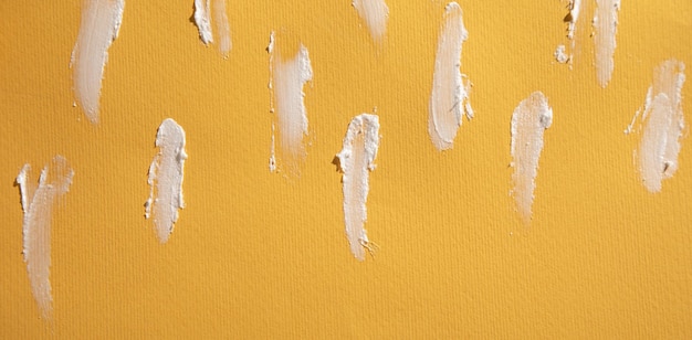 White cosmetic cream on yellow background