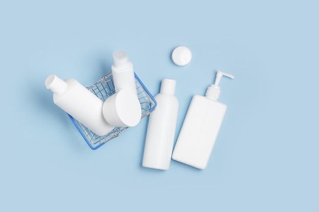 White cosmetic jars lie in a shopping basket