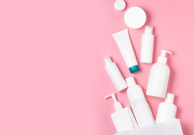 White cosmetic jars on a pink background. Cosmetics for skin care