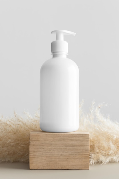 White cosmetic liquid soap dispenser bottle mockup with a pampas decoration