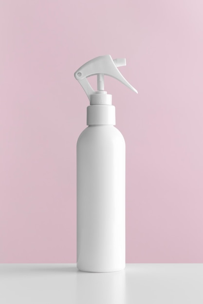 White cosmetic trigger sprayer bottle mockup with pink background