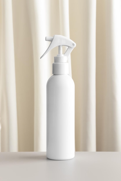 White cosmetic trigger sprayer bottle mockup with a yellow textile