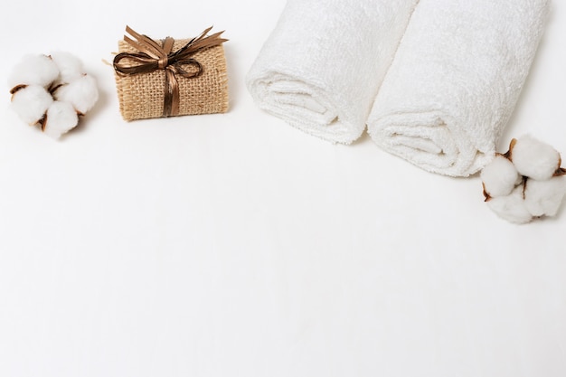 White cotton flower and cotton towels with soap