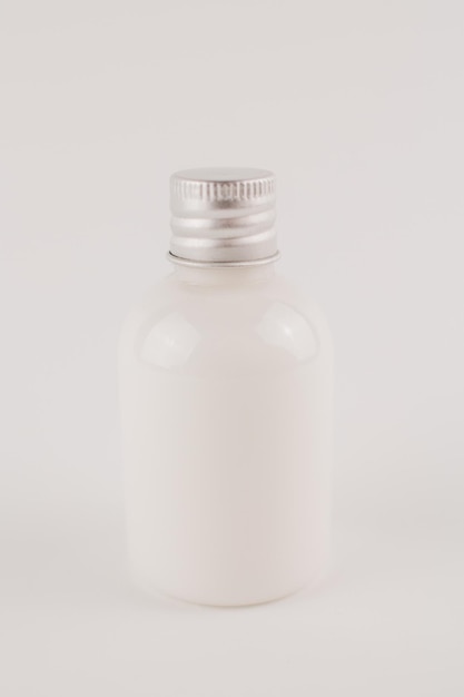 White cream in a transparent jar on a white background