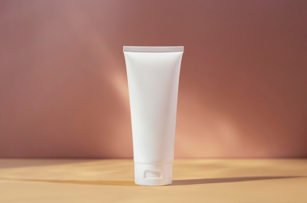 White cream tube mockup isolated on pink blurred background cosmetics mock up skin care