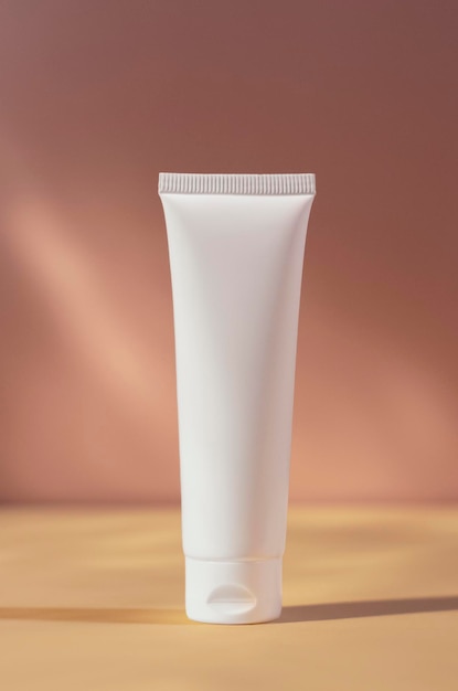 White cream tube mockup isolated on pink blurred background cosmetics mock up skin care