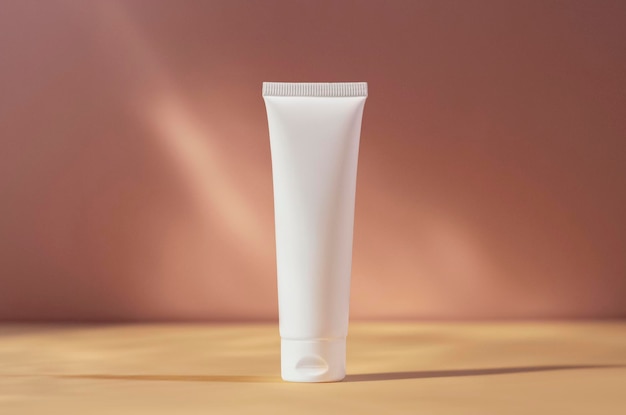 White cream tube mockup isolated on pink blurred background cosmetics mock up skin care