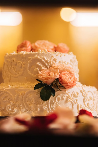 White creamy cake decorated with rosebuds.