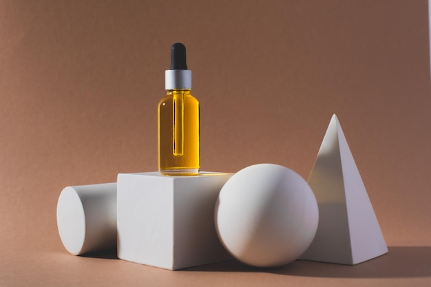 White cube podium with bottle of essential oil on it