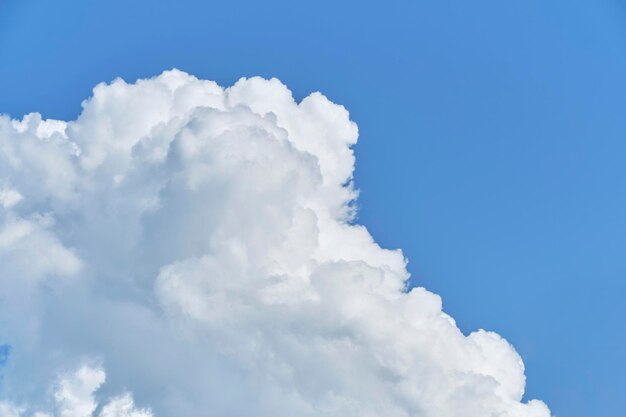 White cumulus clouds against blue sky