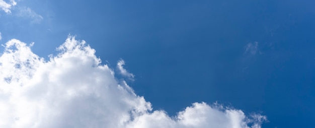 White cumulus clouds in the blue sky background