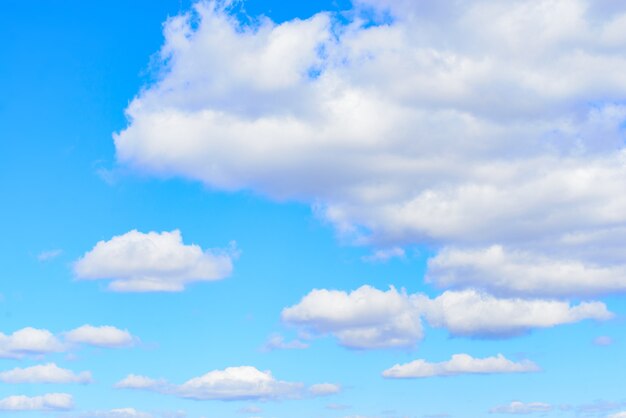 White cumulus clouds in blue sky at daytime. Natural background photo texture.