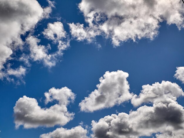 White cumulus clouds in the deep blue summer sky Fluffy clouds background