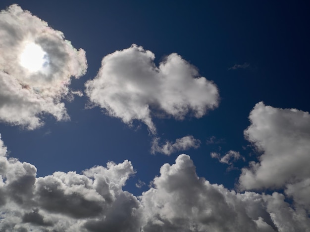 White cumulus clouds in the deep blue summer sky Fluffy clouds background