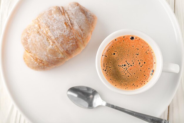 Foto coppa bianca di caffè nero su uno sfondo chiaro