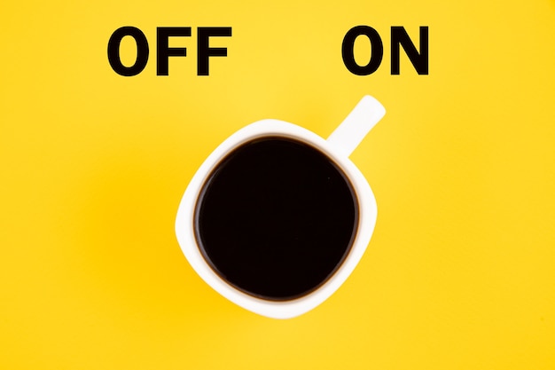 White cup of coffee is turned on. concept on a yellow background