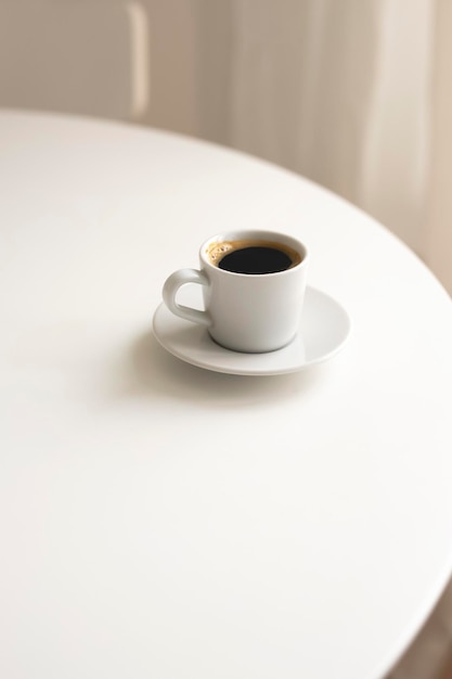 White cup of coffee on a table. Hot drink