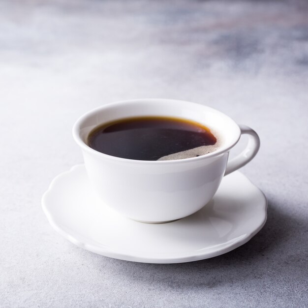 White cup of coffee with amaretti cookies