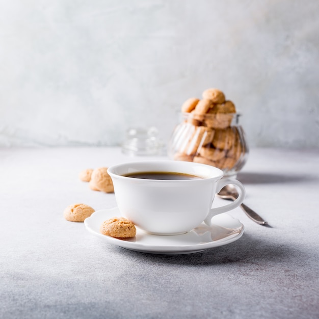 White cup of coffee with amaretti cookies