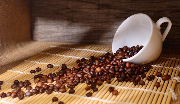 White cup of coffee with coffee beans