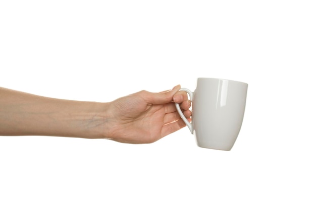 White cup in the female hand