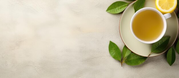 Photo white cup of green tea with lemon viewed from above on a plate isolated on a isolated pastel background copy space