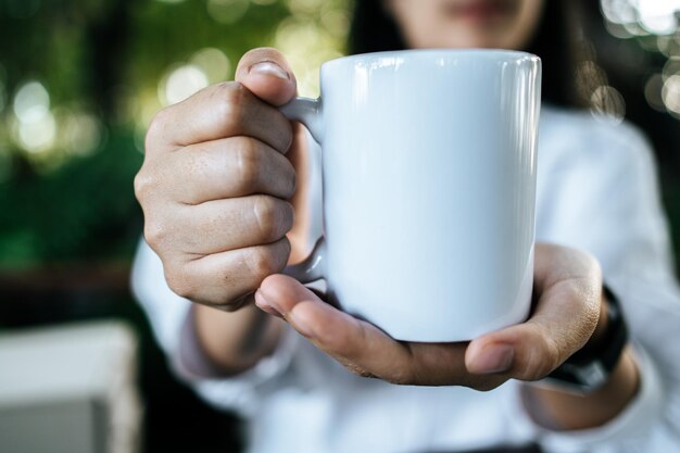 white cup on hand in relax time