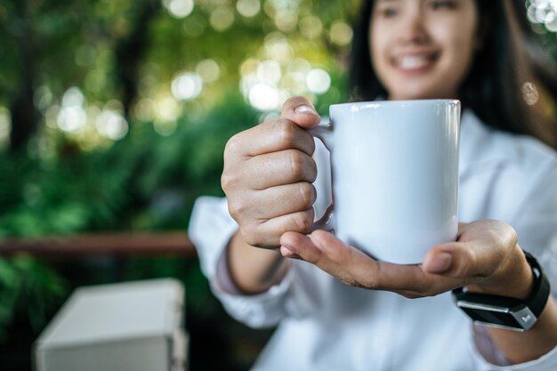 white cup on hand in relax time