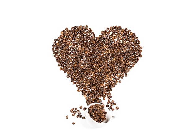 White cup and heart symbol made from coffee seeds isolated on white