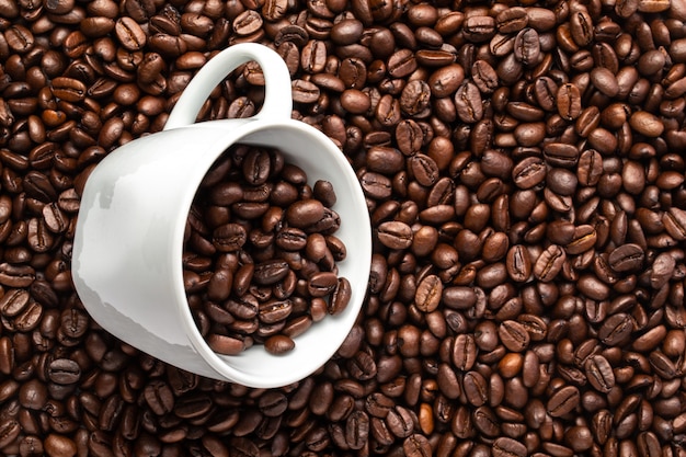 White cup with coffee beans closeup