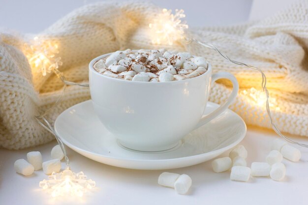 White cup with hot cocoa with marshmallows. Christmas or New Year background with hot chocolate.