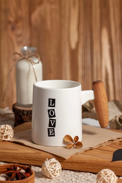 White cup with tea or coffee on wooden table