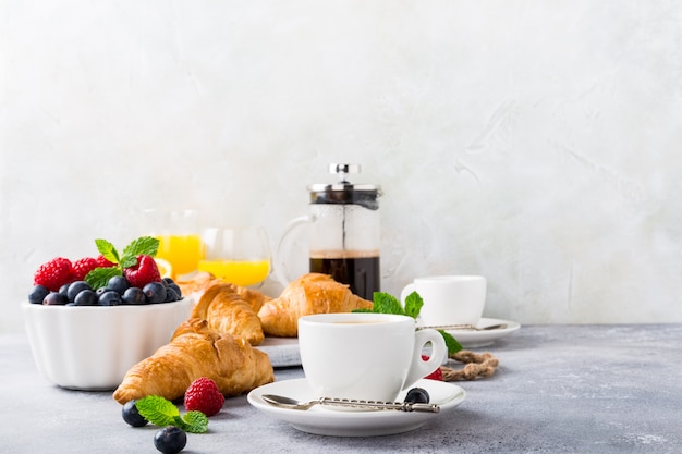 White cups of coffee and croissants