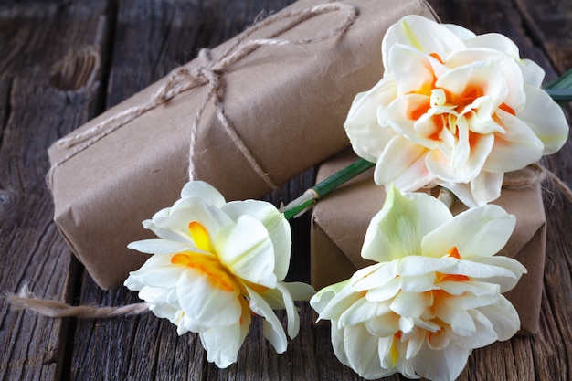 White daffodil flowers on old wood table