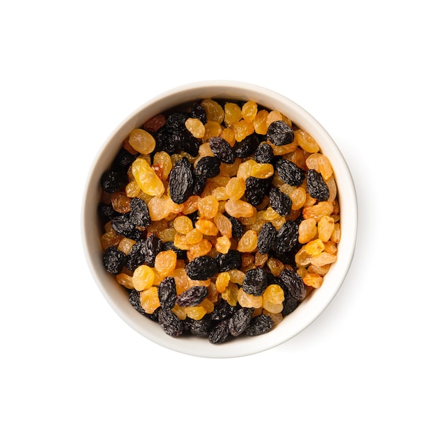 White and dark raisins in a bowl top view on a white background