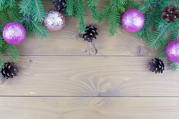 White decorative ball on the christmas tree on glitter bokeh background with blurred snow Happy New Year