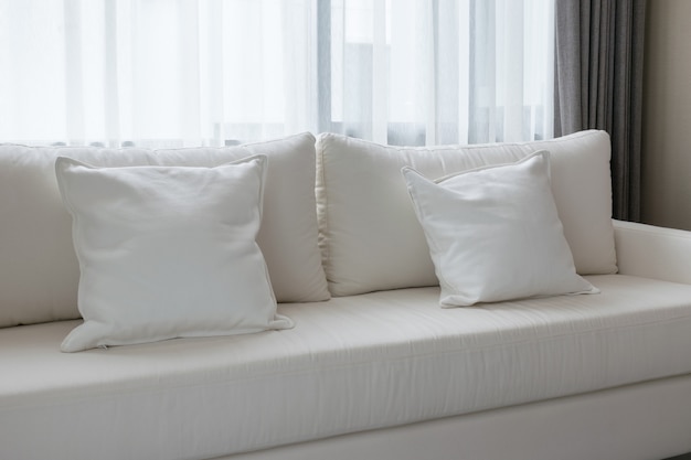 White decorative pillows on a casual sofa in the living room