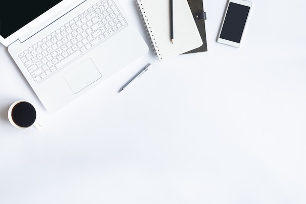 White desk office on flat lay. Top view on desk table essential elements.