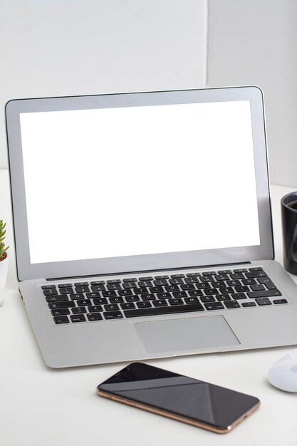 White desk office with laptop smartphone and other work supplies with cup of coffee Designer workspace on desk table essential elements on flat lay