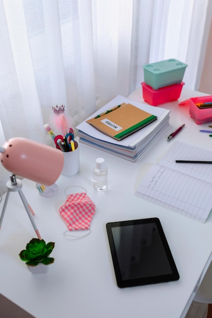 Photo white desk with equipment in girls bedroom