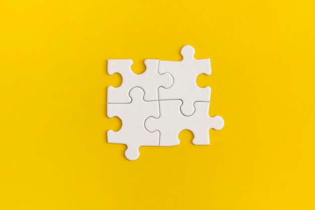 White details of puzzle on yellow background.