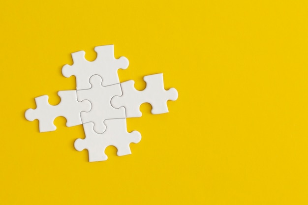 White details of puzzle on yellow background