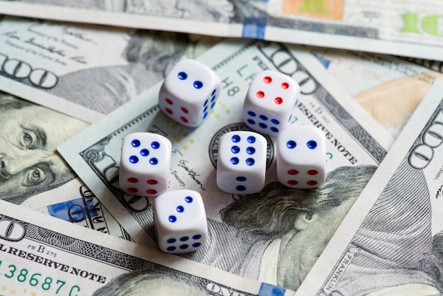 White dice are on a dollar bill of US dollars.