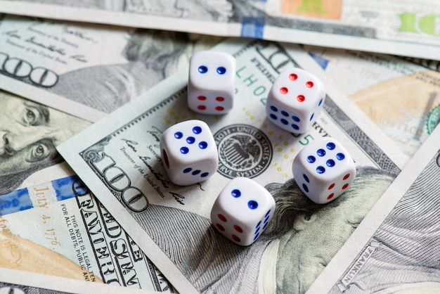 White dice are on a dollar bill of US dollars.