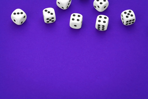 White dices against a purple background