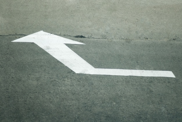 White direction arrow on the road