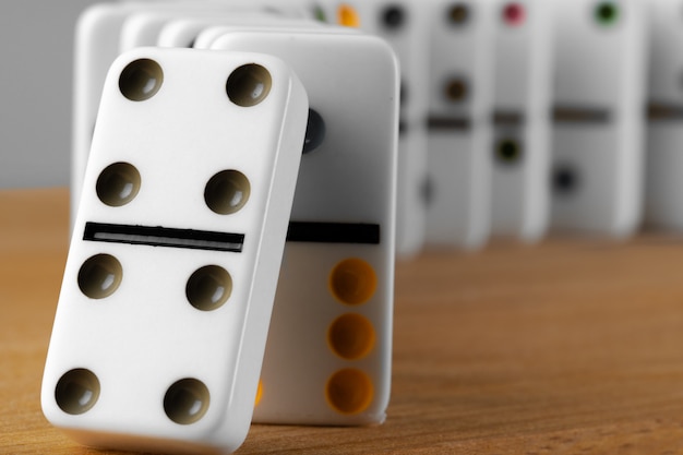 White domino dice on a wooden table