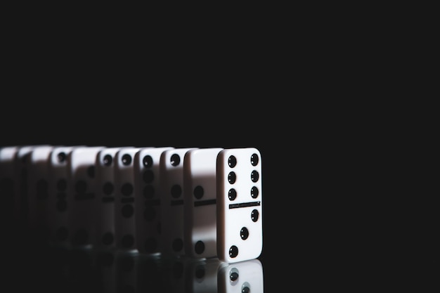 White dominoes in the dark close up